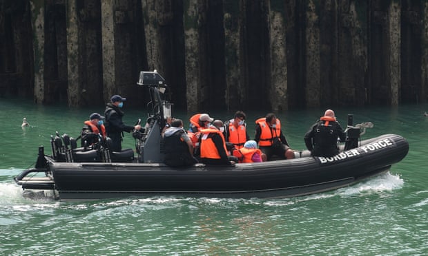 People believed to be migrants arrive in Dover on a Border Force boat, 12 August.