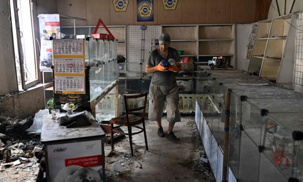 A man salvages goods from a destroyed store in  Sloviansk