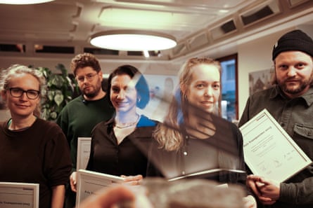 A group of people hold framed certificates saying ‘Prix Transparence 2025’