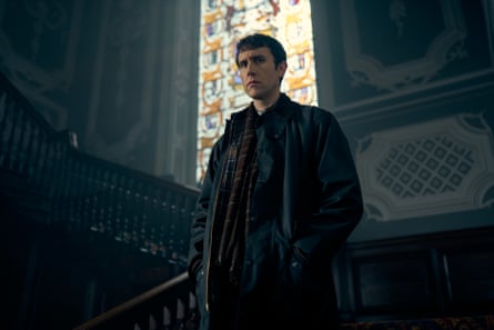 Daniel Clement (Matthew Lewis) standing on the stairs of a church with a stained glass window behind him