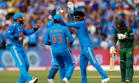 India's Ravindra Jadeja celebrates with teammates after taking the wicket of Bangladesh's Litton Das.