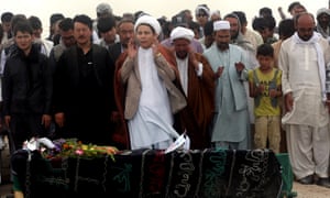 Afghans pray for victims of Saturday’s suicide attack.
