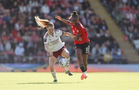 Manchester United’s Melvine Malard and Arsenal’s Katie Reid battle for the ball