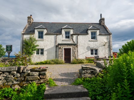 A view of a white washed, stone pub