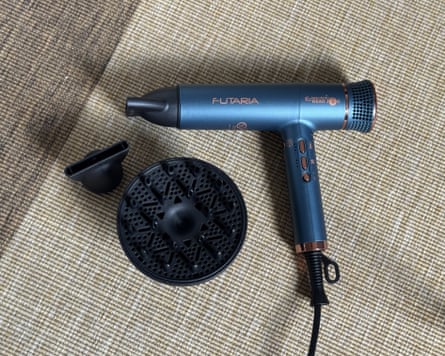 Electric Head Jog Futaria hairdryer in metallic blue with nozzle and diffuser placed next to it.
