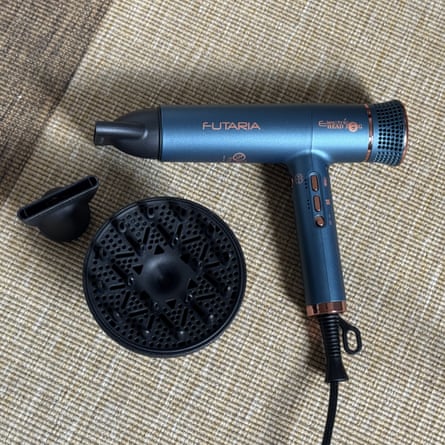 Electric Head Jog Futaria hairdryer in metallic blue with nozzle and diffuser placed next to it.