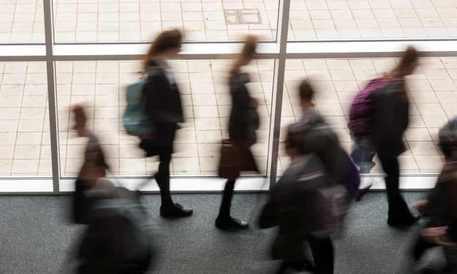 blurred figures of students on a walkway