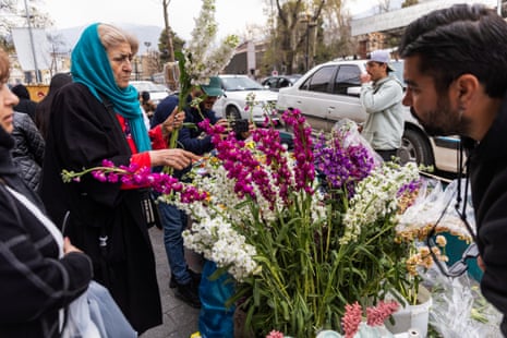 A woman shops for flowers at a market in preparation for Nowruz celebrations on 19 March 2026 in Tehran, Iran.