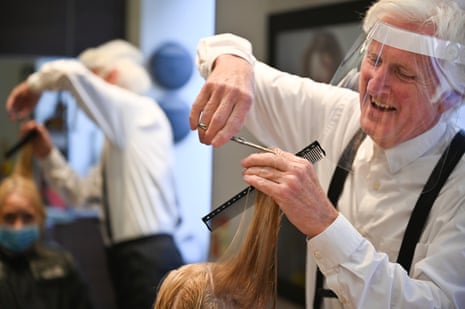 Hairdresser Taylor Ferguson cuts Yvonne Smiths hair, his first customer since the country went into lockdown in March, on July 15, 2020 in Glasgow, Scotland.
