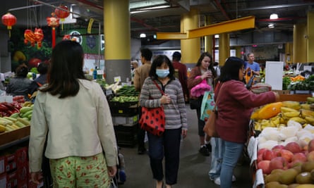 People shop for fruit and vegetable produce at Paddy’s Markets.