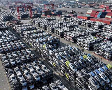 cars lined up and piled up ready for loading on to car carrier container ships