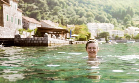 Woman swimming in Kotor Bay on sunny day