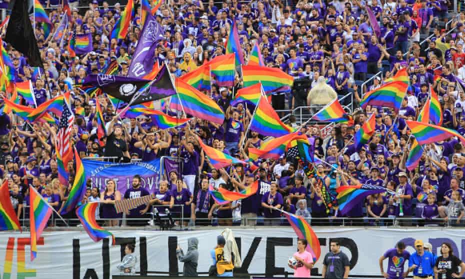 Fans of Orlando Pride’s affiliate club, Orlando City, wave pride flags after the Pulse nightclub shootings in 2016. Both teams have forged links with the LGBTQ+ communities