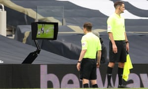 Referee Peter Bankes checks VAR before awarding a penalty.