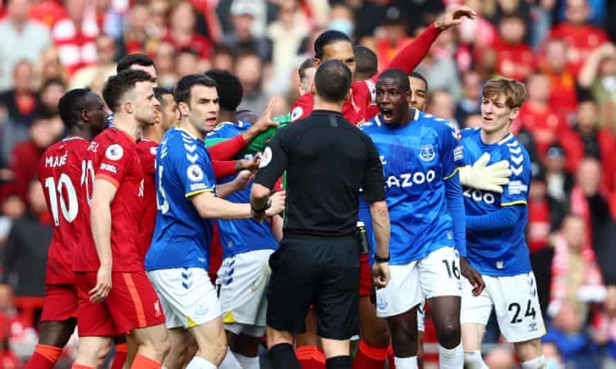 Liverpool and Everton players clash.
