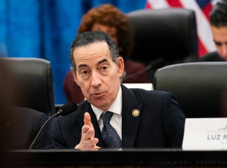 Man seated gestures with one hand