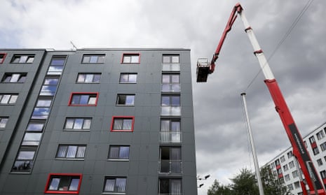 Workers remove cladding for testing from one of the tower blocks in Salford.