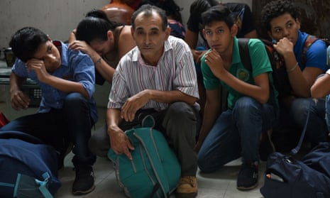 Migrants from Central America crouch in a Mexican detention centre