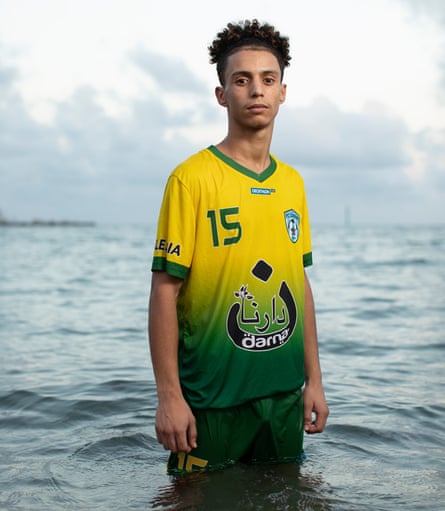 Zakaria Ezzouyn standing in a football shirt in the sea