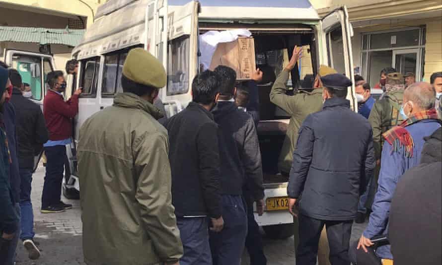 Police load a coffin of a victim of the stampede in the nearby town of Katra.