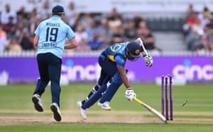 Chamika Karunaratne surves a run out attempt by Chris Woakes.
