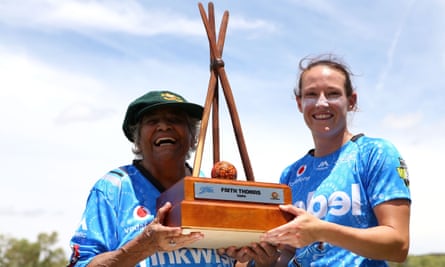 Faith Thomas poses with Megan Schutt and the Faith Thomas Trophy in Alice Springs ahead of a Women's Big Bash League in 2018.