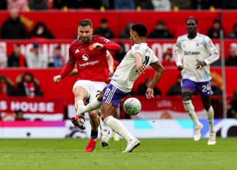 Aston Villa's Ollie Watkins is tackled by Manchester United's Luke Shaw during the Premier League match between Manchester United and Aston Villa at Old Trafford on March 15, 2026 in Manchester, United Kingdom.