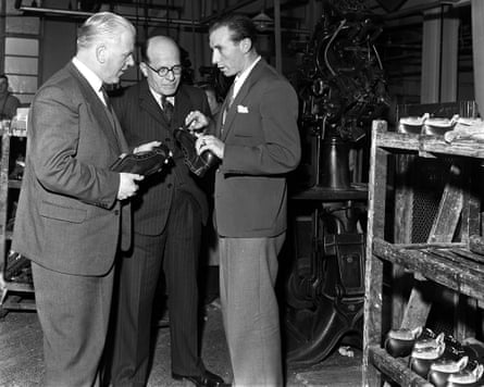 Footballer Stanley Matthews discusses shoe designs with two experts in a factory