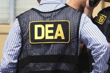 A man in a mesh DEA vest.