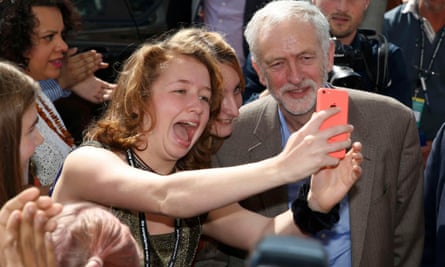 ‘Corbynmania’: Corbyn poses for a selfie with a supporter as he arrives at the beginning of the Labour conference in Brighton.