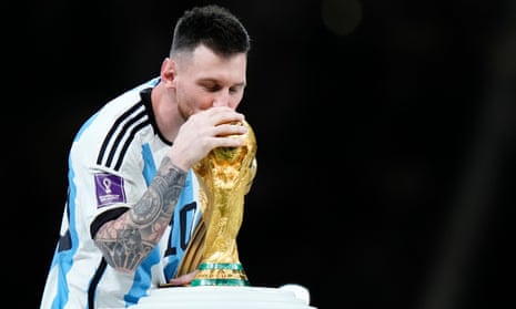Lionel Messi kisses the winner's trophy after Argentina’s victory in the 2022 World Cup final in Qatar.