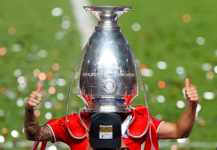 Bayern Munich’s Lucas Hernandez poses with the Champions League trophy in Lisbon