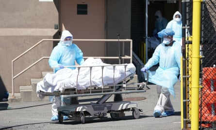 Bodies are moved to a refrigeration truck serving as a temporary morgue at Wyckoff Hospital in Brooklyn, New York, on 6 April.