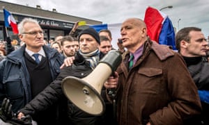 Gen Christian Piquemal, second right, addresses demonstrators at the rally