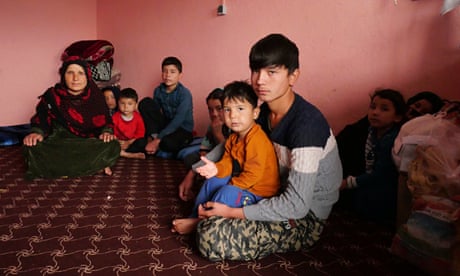 Zebah Gul sits with her eight children in the room at the transit centre in Herat, Afghanistan, after being arrested at the Iran-Turkey border