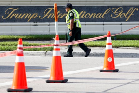 A law enforcement officer walks after reports of shots fired outside Trump International Golf Course in West Palm Beach.