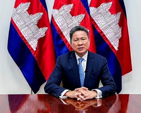Sun Chanthol sitting at a desk with hands clasped