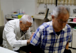 Nagayama examines a patient at his hospital in Tokyo. As a doctor, he is aware of the risks involved in playing a high impact sport at his age and the club’s website gives advice on health precautions and even links to a life insurance company