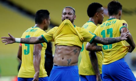 Neymar lifts his shirt after scoring against Peru, in response to suggestions he is overweight.