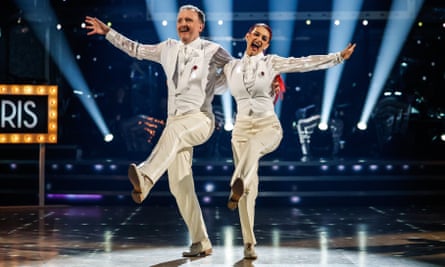 McCausland and Buswell perform on Strictly Come Dancing while dressed in white suits.