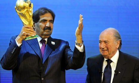Sepp Blatter, right, and Sheikh Hamad bin Khalifa Al-Thani, Emir of Qatar, with the World Cup trophy after Qatar was announced as the host for 2022.