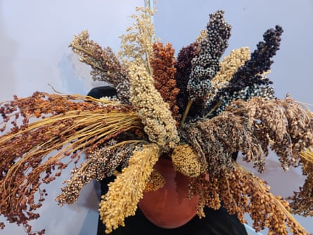Closeup image of a pot overflowing with a variety of millet in differing colours.