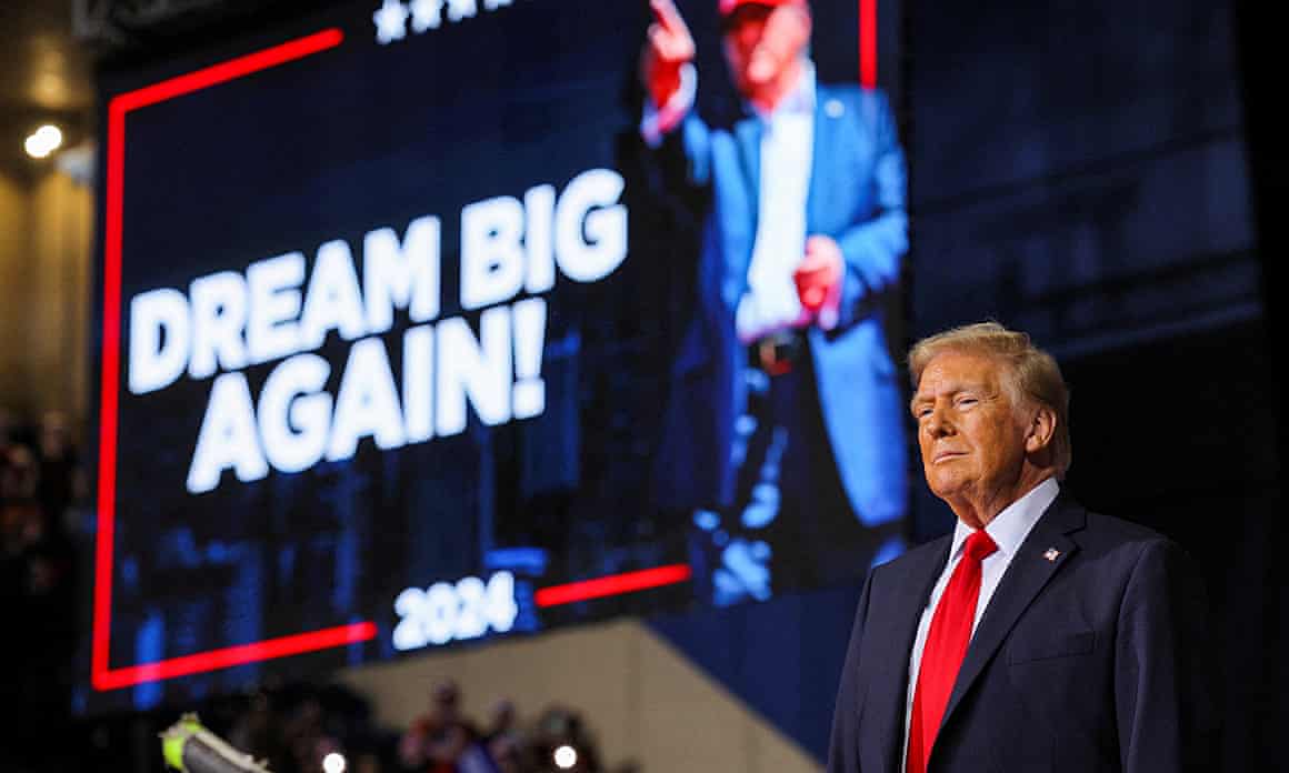 Donald Trump seen in front of a billboard saying 'Dream Big Again'