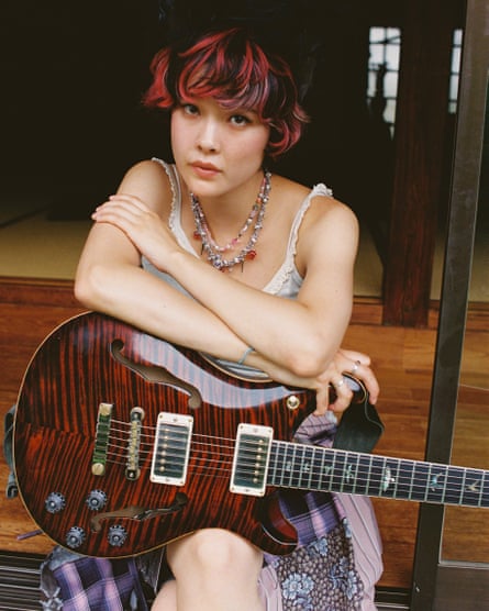 Mei Semones holding her guitar