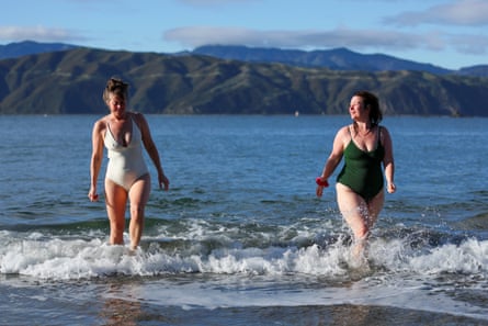 Natalie Keegan (L) and Melody Thomas take a dip in the sea before heading to the sauna