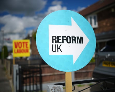 A Reform UK placard in Makerfield – with a 'Vote Labour' sign out of focus in the background