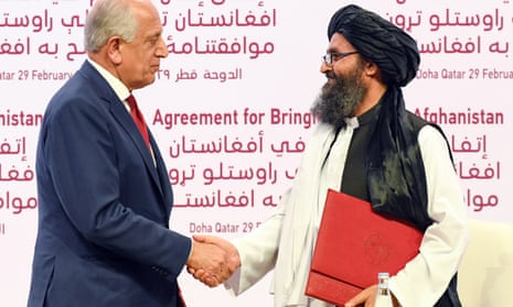 US Special Representative Zalmay Khalilzad and Taliban co-founder Mullah Abdul Ghani Baradar shake hands in Doha, Qatar.