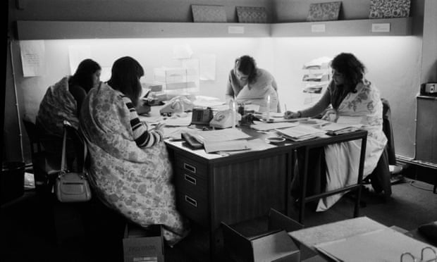 Women work in an office during a power cut