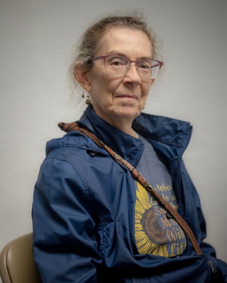 Woman wearing glasses and blue windbreaker indoors