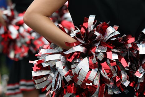 Young cheerleader with red silver and black pompom